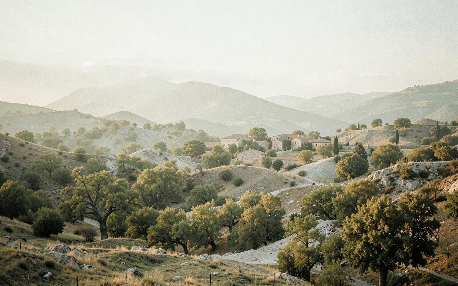 Collines et village de pierre du Sud-Ardèche dans la brume du matin