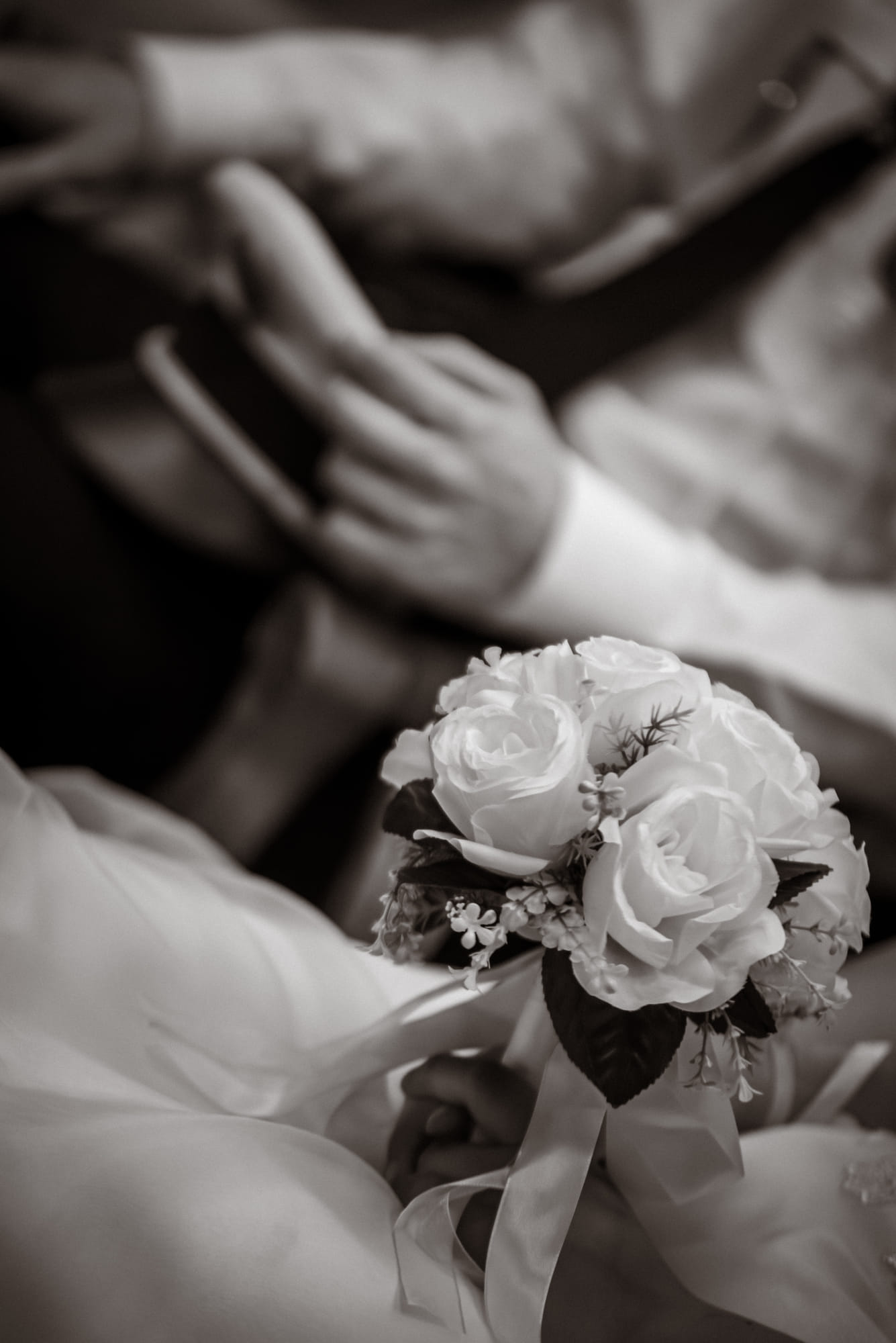 Bouquet de Chloé, roses claires tenues à deux mains, en noir et blanc